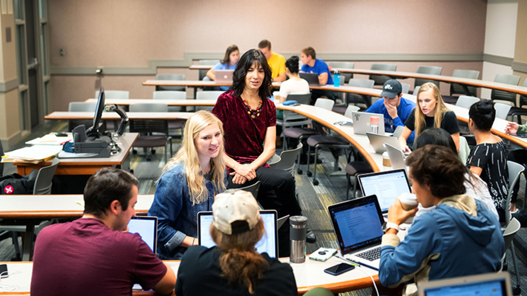 UI instructor engaging with students in an active learning environment on campus. 